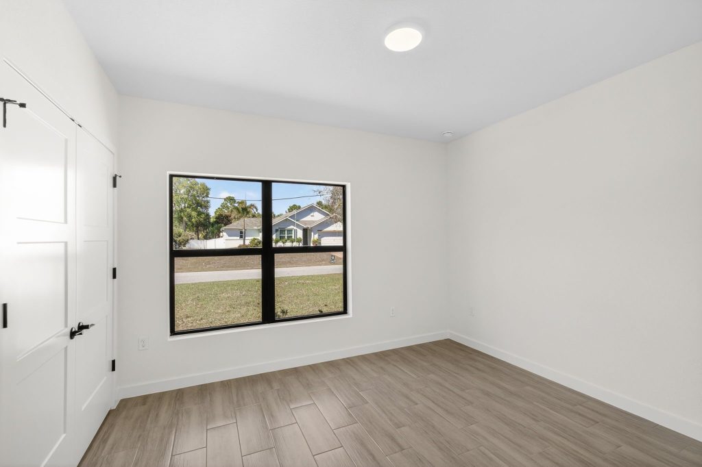 Bedroom with large window and recessed lighting