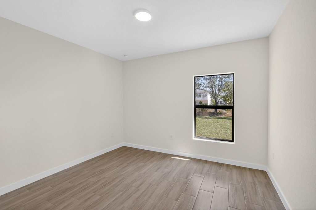 Bedroom with window view in a completed AM Homes build