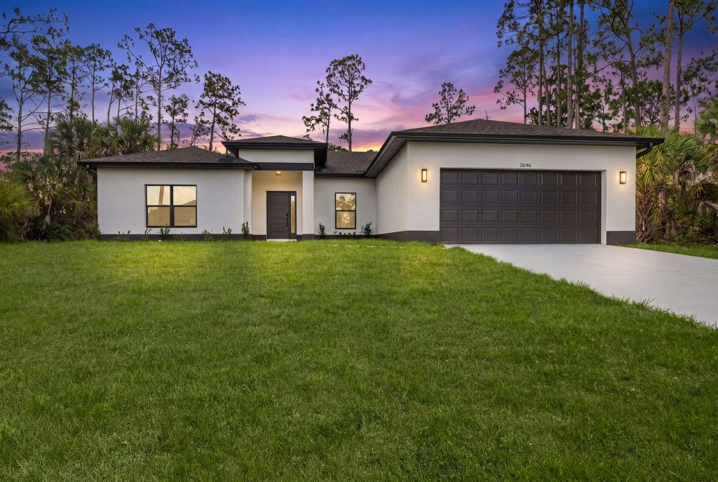 AM Homes model home at twilight – modern exterior with two-car garage